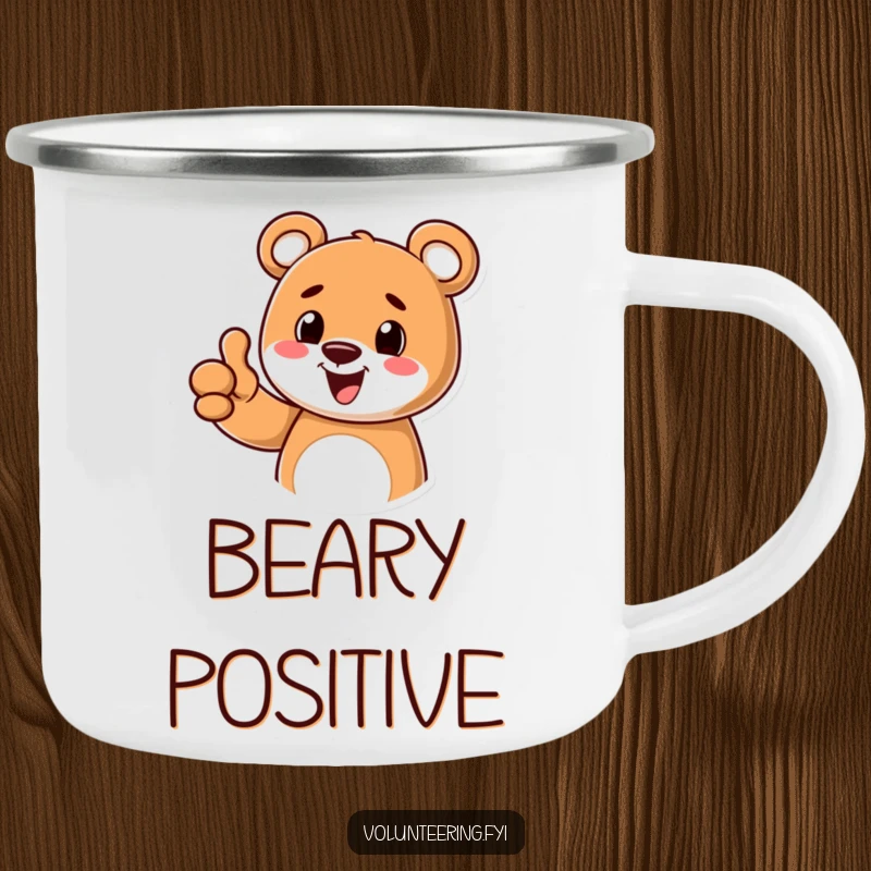 Funny enamel camping mug featuring a cheerful cartoon bear giving a thumbs up, perfect for enjoying beverages during outdoor activities.