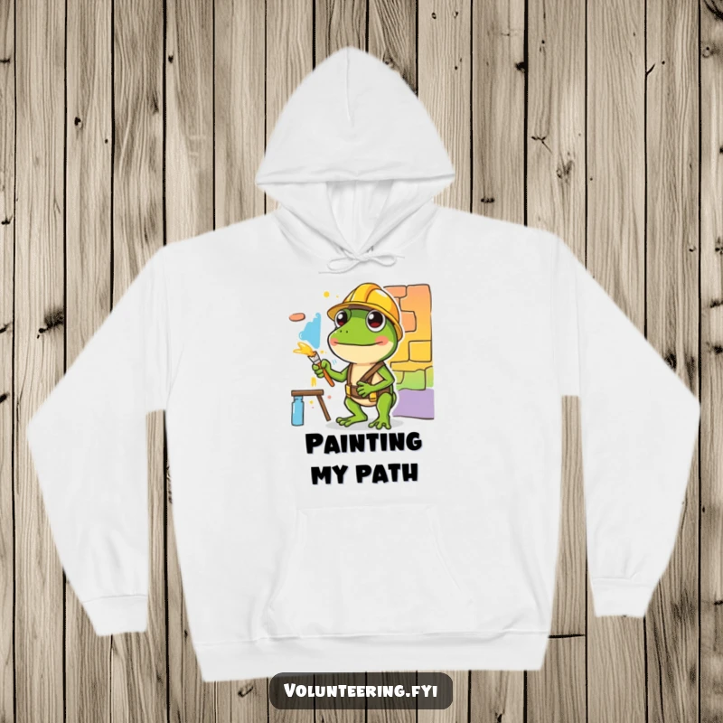 Funny hoodie featuring a diligent green frog with a hard hat painting, offering cozy humor and artistic style.