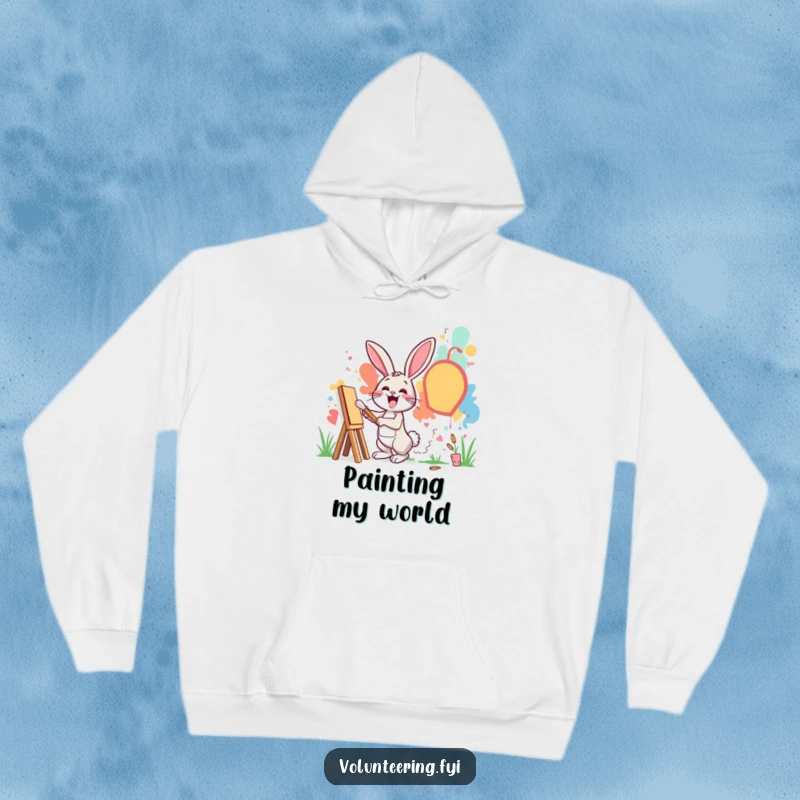 Funny hoodie depicting an excited rabbit painting a mural on a community wall, cozy wear for art enthusiasts.