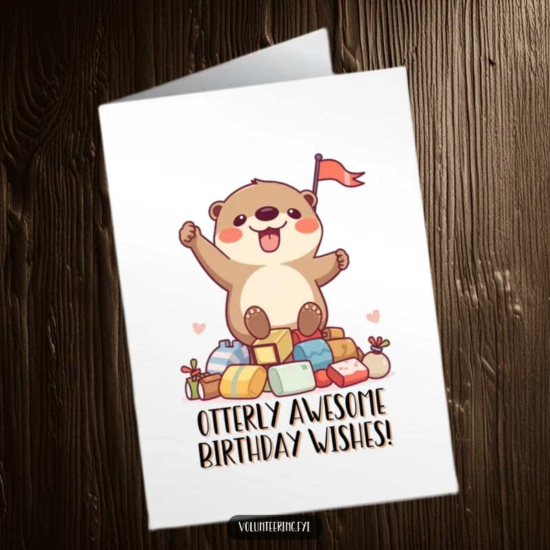 Funny free printable birthday card featuring a playful otter enthusiastically waving a flag from a pile of gifts.