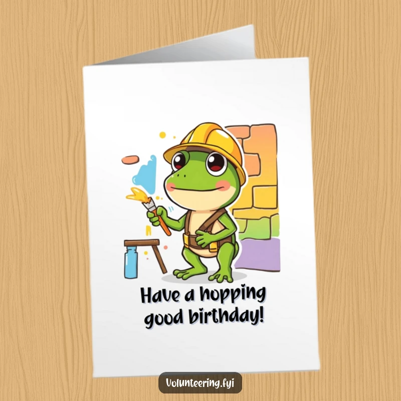 Funny Free Printable Birthday Card: A green frog in a hard hat carefully paints a colorful mural section with dedication.