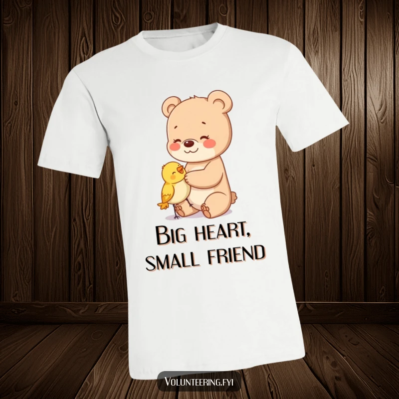 Funny t-shirt featuring a cuddly bear cub tenderly patting a small, surprised bird, celebrating gentle interactions.